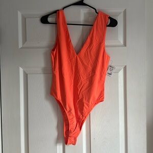 Neon orange body suit